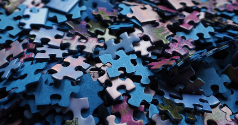 Pile of brightly coloured jigsaw puzzle pieces