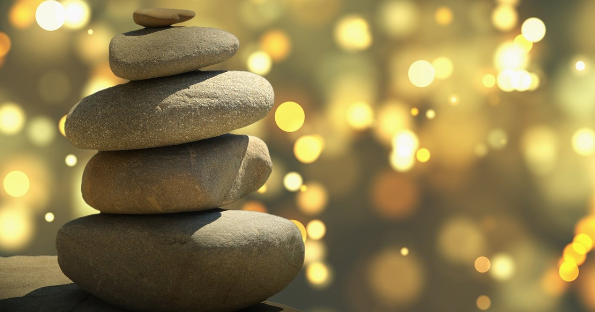 Stack of smooth stones against a bokeh background