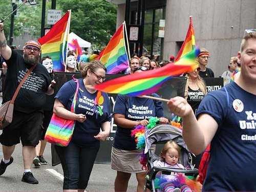 People march holding pride flags during the 2018 Cincinnati Pride parade